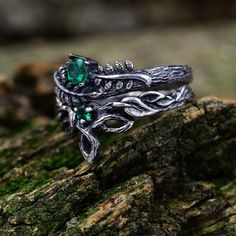 These sterling silver rings, inspired by the beauty of nature, showcase a unique blend of Celtic and Elven designs. The set features delicate stacking rings adorned with birthstones and intricate leaf branches, adding a whimsical touch to the overall design.  Characteristics: Metal - Recycled solid sterling silver  Stone - Cubic Zirconia Finish - Oxidized. View all silver forest rings: https://www.etsy.com/shop/TinyShinyJewel?ref=seller-platform-mcnav&section_id=43358995 Care instructions: To care for the ring, avoid contact with water and chemicals such as perfumes and lotions. When the ring is not in use, store it in a dry, cool place to prevent tarnishing. Additional information:  ✦ All rings are made to order. An average turnaround time is 1-5 days. I will make every effort to ship the Emerald And Black Ring, Celtic Wedding Ring Sets Unique Celtic Wedding Rings, Wedding Rings Forest Theme, Dark Green Stone Ring, Fae Wedding Rings, Elven Engagement Ring, Forest Wedding Rings, Unconventional Rings, Dark Wedding Rings