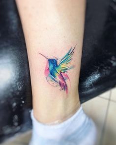 a colorful hummingbird tattoo on the ankle