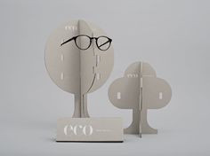 a clock with glasses on top of it next to a pair of eyeglasses