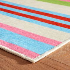 a multicolored striped rug on the floor