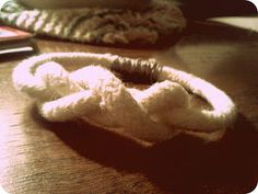 a pair of white slippers sitting on top of a wooden table