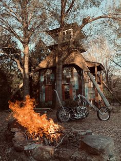 a motorcycle parked next to a fire in front of a building