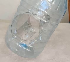 a large plastic water bottle sitting on top of a table