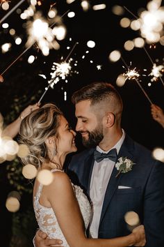 Husband and Wife on wedding day hugging with bright sparklers surrounding them Sparklers Wedding Pictures, Wedding Sparklers Photos, Sparkler Exit Wedding, Wedding Fotos, Buffalo Wedding, Wedding Exit