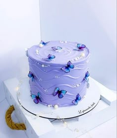 a purple cake sitting on top of a white box