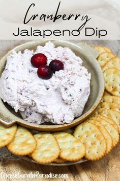 cranberry jalapeno dip in a bowl with crackers on the side