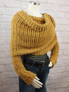 a mannequin wearing a yellow sweater and jeans