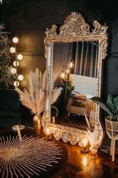 a mirror sitting on top of a wooden table next to a chair and potted plant