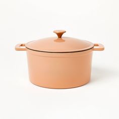 an orange casserole dish on a white background