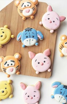 winnie the pooh and tigger cookies on a cutting board with winnie the pooh