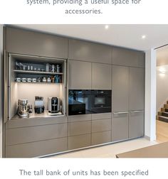 a modern kitchen with stainless steel appliances and built - in shelving unit for storage