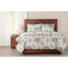 a bed with blue and white shells on it