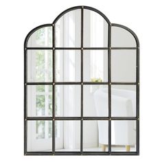 an arched mirror is shown in front of a window