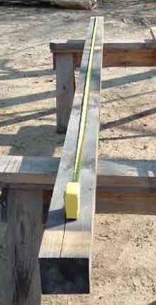 a wooden bench sitting on top of a sandy beach