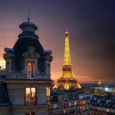 the eiffel tower is lit up at night