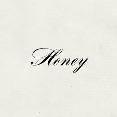 the word honey written in cursive writing on a white paper with black ink