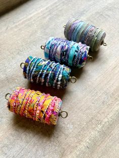 three different colored bracelets sitting on top of a table