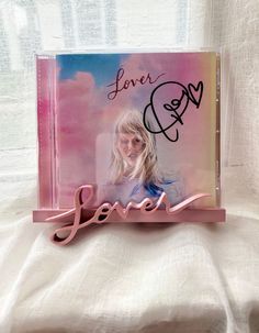 a pink album with the word love written in cursive writing on it's cover