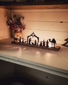 lighted nativity scene displayed on shelf in room