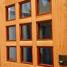 a close up of a wooden door with glass panes on the front and side