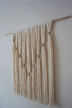 a wall hanging made out of yarn and wooden pegs, with the words save on it