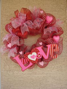 a valentine's day wreath with the word love on it