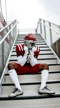 a football player is sitting on the stairs