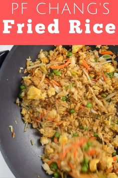 fried rice with peas and carrots in a black skillet on a white surface