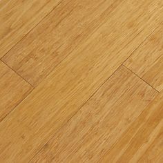 an orange cat laying on top of a wooden floor