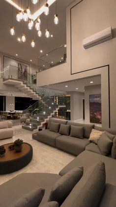 a large living room with couches and stairs