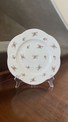 a white plate sitting on top of a wooden floor