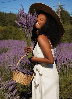 a woman standing in a field with lavender flowers