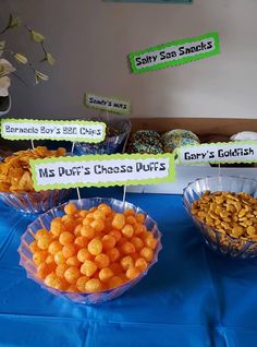 there are some snacks on the table for guests to eat at this birthday party, including donuts and cheesy puffs