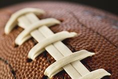 a close up of a football with white stitching