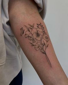 a black and white flower tattoo on the arm