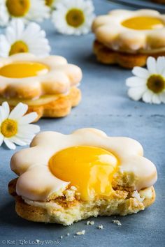 an egg is on top of some biscuits with flowers in the backgroung