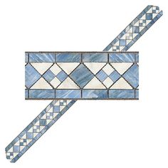 a blue and white mosaic tile strip with diamond design on the end, in an angled position