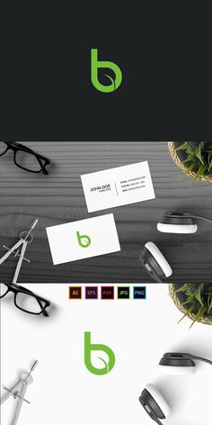 an assortment of business cards and eyeglasses on top of a wooden table next to a potted plant