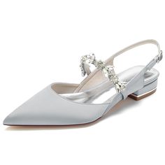 a pair of white shoes with jewel decorations on the toe and heel, all in satin fabric