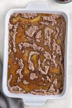 a baking dish filled with brownies and powdered sugar on top of a table