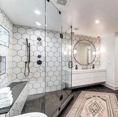 a bathroom with white walls and black flooring