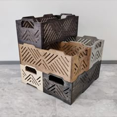 three wooden boxes are stacked on top of each other, one is made out of wood