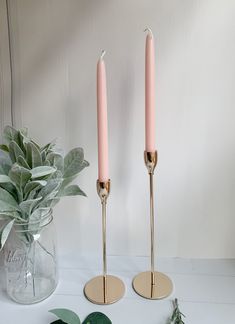 two candles are sitting next to each other on a table