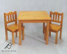 a wooden table and two chairs with a bird sitting on the chair next to it