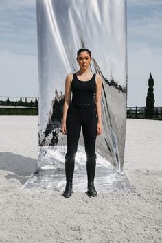 a woman standing in front of a large metal object