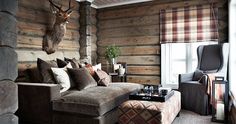 a living room filled with furniture and a deer head mounted to the side of the wall