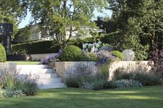 an outdoor garden with stone steps and flowers