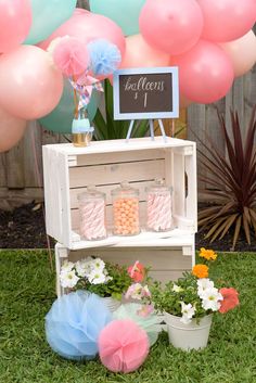 an outdoor birthday party with balloons and decorations