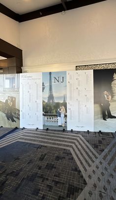 a large carpeted room with posters on the wall