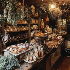 a bakery filled with lots of different types of breads and pastries on display